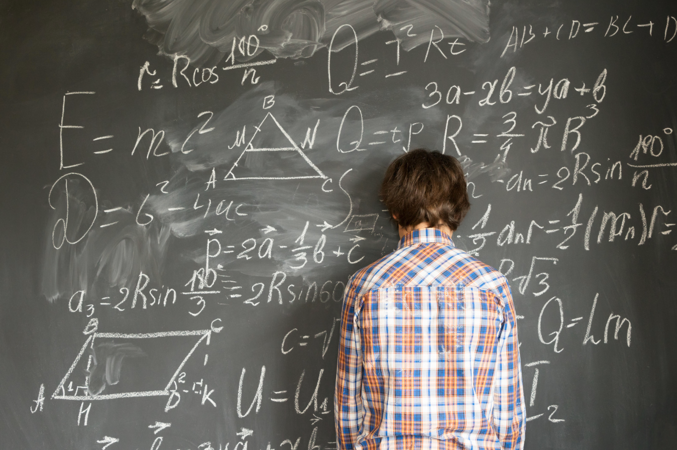 boy leaning on blackboard