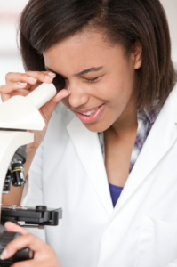 student with microscope