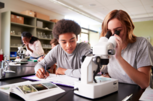 2 IB students with microscope