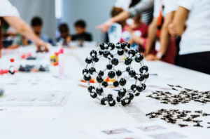 Group of students in biology class creating molecular models