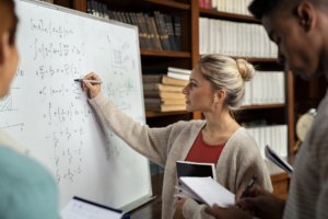 maths teacher at whiteboard